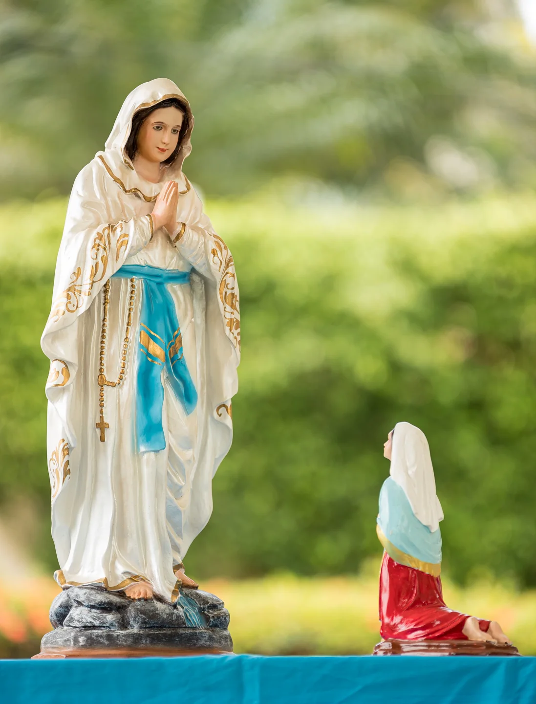 A Marian statue set in a peaceful garden